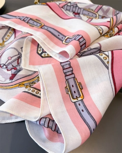 Close-up of vintage equestrian belt pattern on twill silk scarf with fine texture