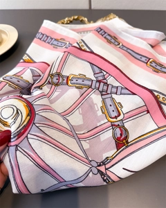 Close-up showing the diagonal twill texture and classic horse carriage pattern on the scarf