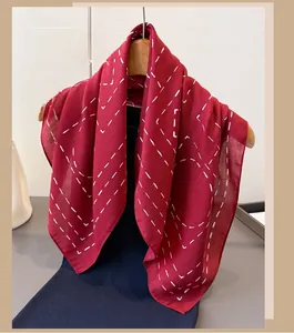 Detailed view of red cotton linen scarf featuring a white dotted geometric line pattern