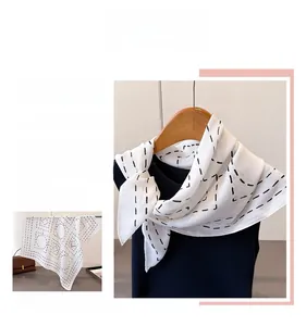 Macro detail of white silk scarf with black geometric dashed lines in a necktie styling