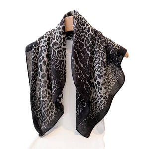 Elegant leopard print cotton-linen scarf displayed on a mannequin with natural drape