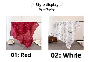 Style display of red and white square scarves with geometric patterns hanging on a rack