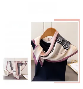 Detail of geometric herringbone pattern scarf in burgundy and beige on a hanger