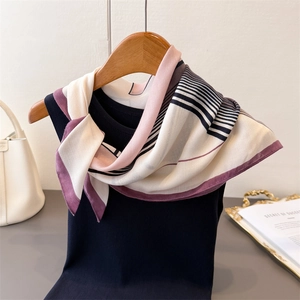Geometric color block silk-like scarf with herringbone pattern on a black top