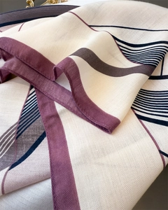 Close-up of geometric herringbone pattern scarf with purple and grey color-blocking detail