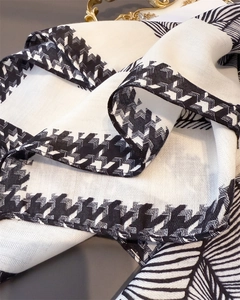 Detail of herringbone cotton linen scarf with black and white houndstooth pattern texture
