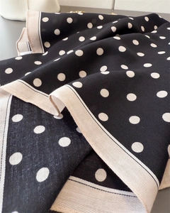 Close-up of herringbone texture on polyester scarf with white polka dots on black