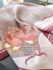 Gros plan d'un foulard en soie avec texture pied-de-poule et motifs floraux