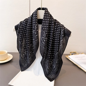 Polka dot and paisley cotton-linen feel scarf elegantly displayed on a hanger