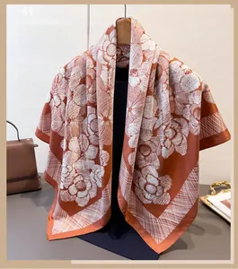 Detail of vintage floral silk scarf in caramel orange with elegant draping on hanger