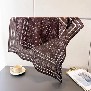 Detail of silk-like square scarf in deep coffee with vintage floral and dot patterns