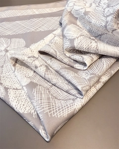 Detail shot of vintage floral pattern and silk-like twill texture on a folded square scarf