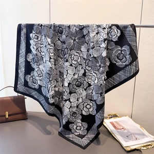 Detail of silk satin square scarf featuring vintage black and white camellia floral prints