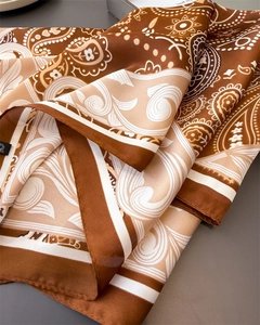 Detailed macro shot of vintage paisley pattern on a silky brown neck scarf