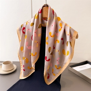 Elegant paisley faux silk square scarf with floral print draped on a wooden hanger
