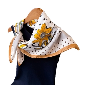 Silk-like floral scarf with yellow flowers and black polka dots on white background