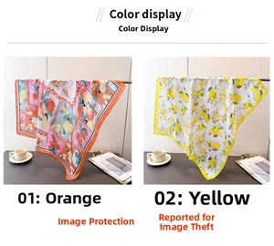 Detail view of silk scarves with lemon and citrus fruit prints in orange and yellow colors