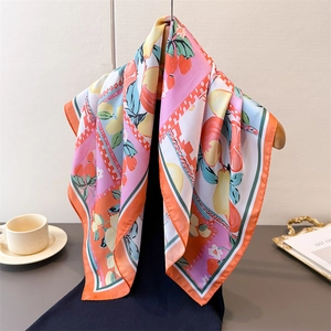 Elegant silk scarf featuring vibrant lemon and fruit prints with contrast borders