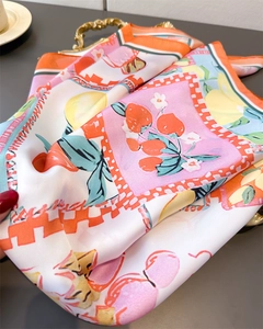 Detailed view of silk square scarf featuring vibrant lemon and peach fruit floral prints