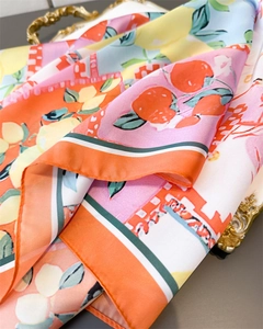 Macro detail of silk-like lemon print scarf showing glossy texture and vibrant colors