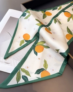 Close-up of double-layer silk twilly scarf with orange citrus print and green border