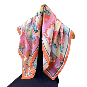 Elegant silk-like square scarf featuring fresh lemon and fruit prints on a white backdrop