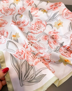 Macro detail of satin silk scarf with pink tulip and yellow daffodil floral print