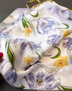 Detail of silk scarf showing realistic lilac tulips and yellow narcissus print on tray