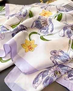 Detail of silk-like scarf featuring romantic purple tulips and yellow floral prints