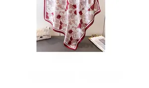 Detail of red rose print faux silk square scarf with floral and geometric patterns