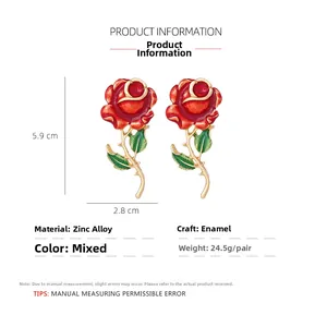 Detail view of red enamel rose earrings with gold stems and precise dimensions