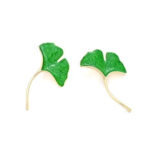 Elegant gold ginkgo leaf earrings with green enamel coating on a clean white background
