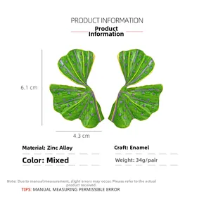 Detail of green and purple enamel ginkgo leaf earrings with dimensions 6.1cm x 4.3cm