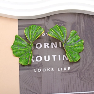 Exaggerated ginkgo leaf earrings with green enamel and purple dots in golden finish