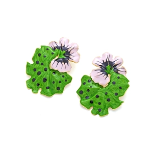 Detail view of light pink floral earrings with green enamel leaves and golden edges