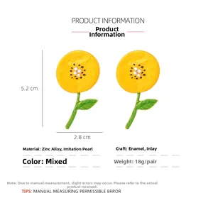 Detail view of yellow sunflower earrings with pearl centers showing 5.2cm x 2.8cm dimensions