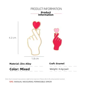 Detail showing red enamel heart gesture earrings with gold plating and dimensions