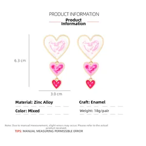 Detail view of tiered heart earrings with marble texture and pink gradient enamel finish