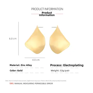 Detailed view of irregular matte gold leaf earrings with 6.0cm by 4.0cm dimensions