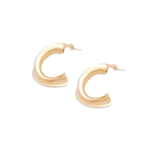 Detailed view of chunky C-shape twisted gold earrings with a polished mirror finish