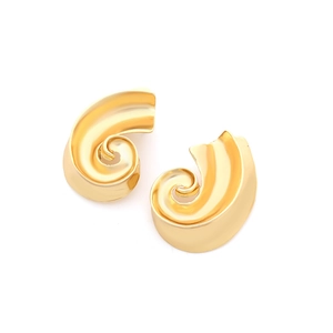 Macro detail of golden spiral wave earrings showing polished metallic curves and 3D design