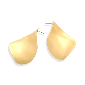 Macro shot of large brushed gold twisted leaf earrings with irregular satin metal texture