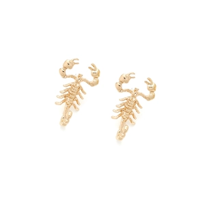 Detailed close-up of golden metallic scorpion earrings with intricate segmented body design