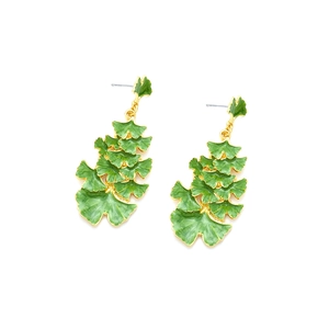 Detailed view of layered green enamel ginkgo leaf earrings with golden metal edges