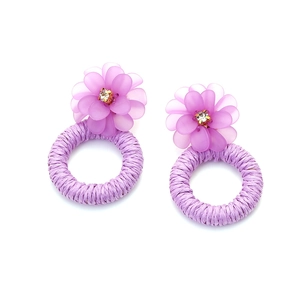 Detail of purple handmade woven resin flower earrings with bohemian crystal accents