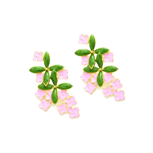 Detail of pink enamel flower earrings with green leaves and golden metal edges