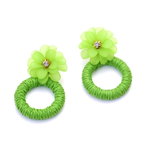Handmade green resin flower earrings with woven raffia circles and crystal center