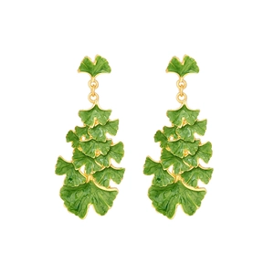 Golden ginkgo leaf earrings with green enamel coating in a layered botanical design