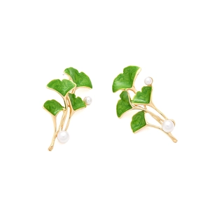 Elegant gold ginkgo leaf drop earrings with green enamel and white pearls detail