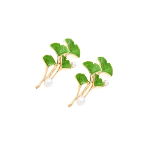 Elegant gold ginkgo leaf earrings with green enamel coating and white pearls